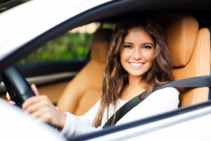 young woman driving car photo
